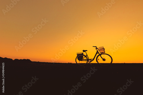 silhouette of the bike on orange sky