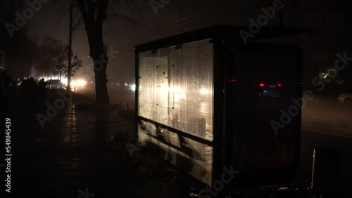 Blackout in the city. No street lightning. Light from cars during fog night.