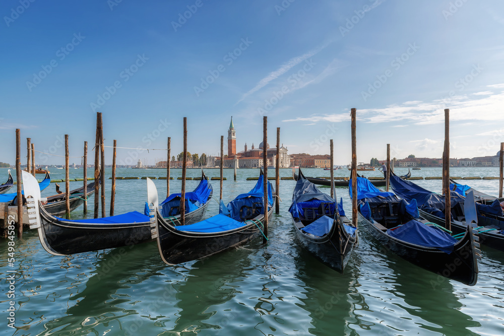 Venice landscape. Gondolas by Saint Mark square with San Giorgio di Maggiore church in Venice, Italy,	