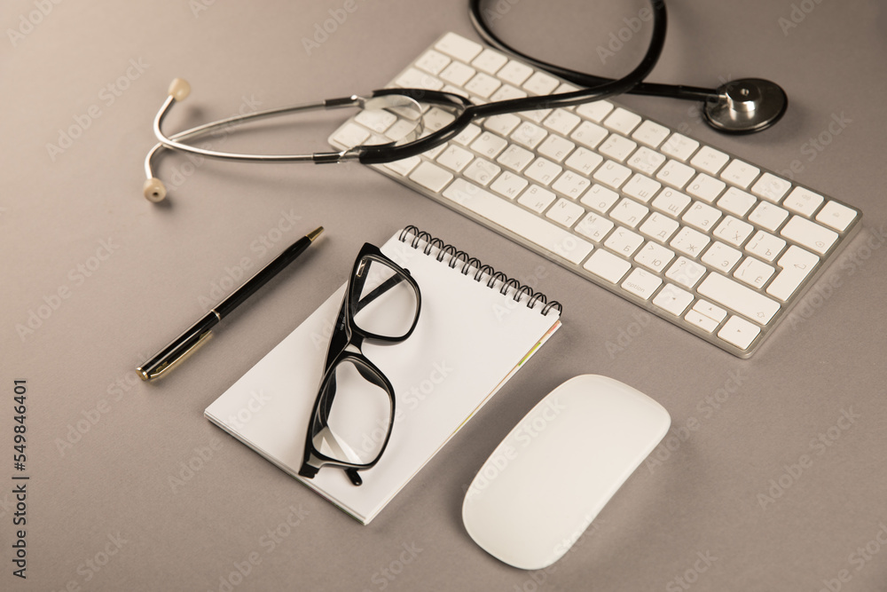 Stethoscope, notepad and keyboard