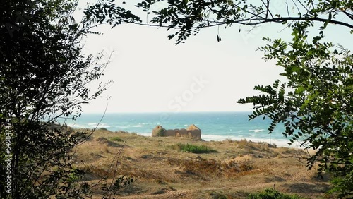 old abandoned beach house 4k. mysterious cinematic beach with an old house on the beach. Destroyed house on beach