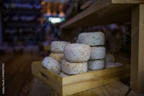 Closeup of stacked truckles of cheese in a wooden box. photo