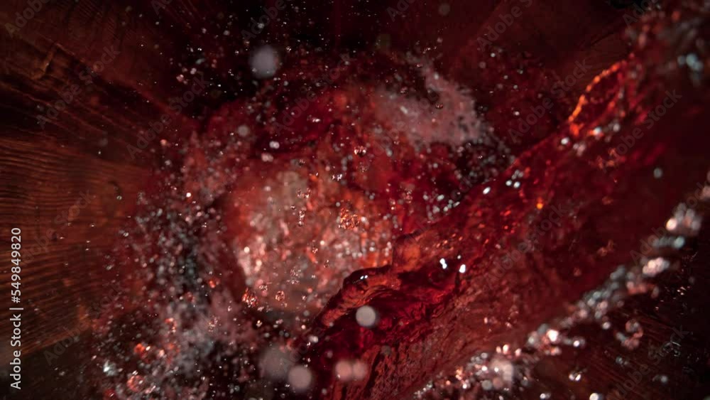 Super Slow Motion Shot of Pouring Red Wine into Old Oak Wooden Barrel at 1000fps. Super Slow Motion Shot of Pouring Red Wine into Old Oak Wooden Barrel at 1000fps.