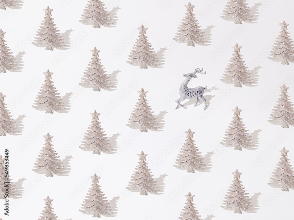 Obraz premium Silver glitter decorative Christmas tree with deer on a white background. Pattern.