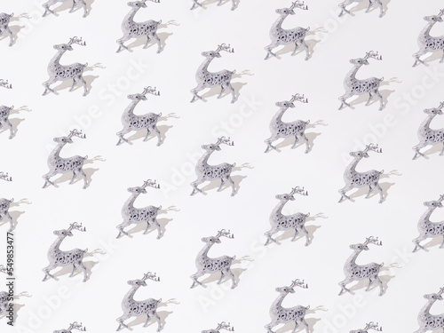 Silver decorative reindeer on a white background. Pattern.