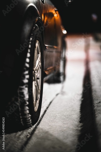 Vertical closeup of a car's wheel on snow