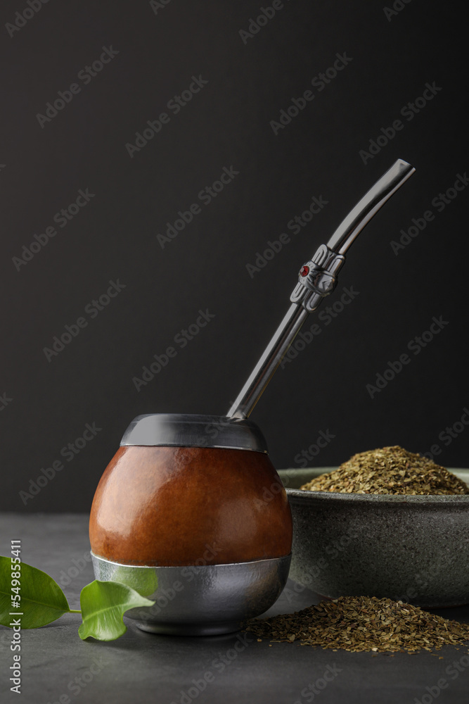 Calabash with mate tea and bombilla on light grey table Calabash with mate tea and bombilla on light grey table