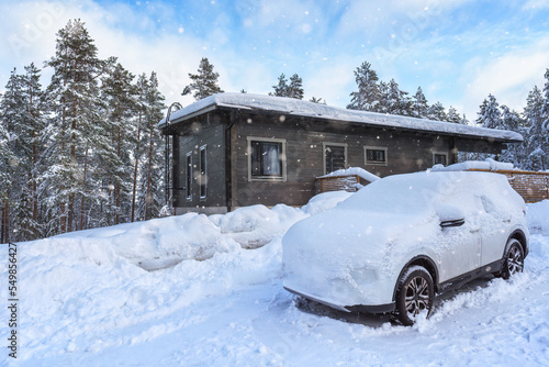 Wallpaper Mural A modern car buried in the snow in front of a cottage. Torontodigital.ca