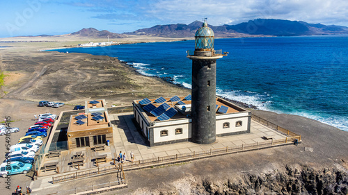 The lighthouse of Punta Jandia in a desert volcanic landscape at the southernmost tip of Fuerteventura in the Canary Islands, Spain - Completed in 1864, it is the oldest lighthouses in the Canaries photo