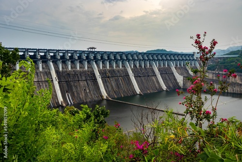 Sardar Sarovar Dam surrounded by greenery and plants with a cloudscape in the background photo