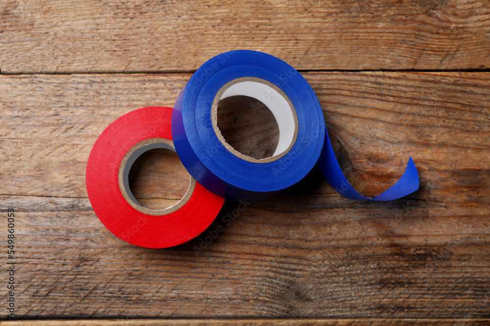 Colorful insulating tapes on wooden table, top view Colorful insulating tapes on wooden table, top view