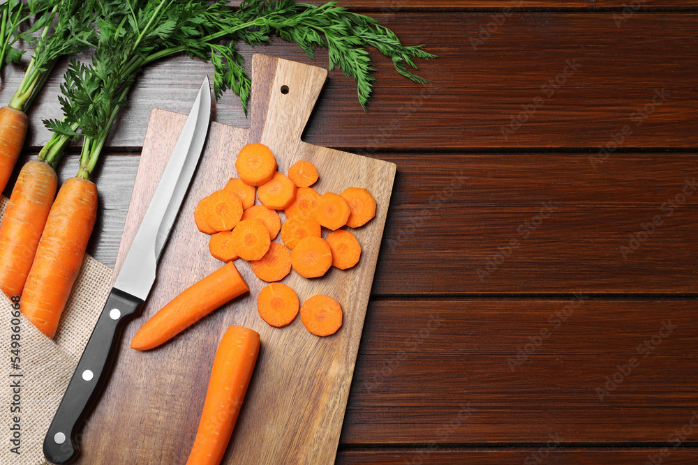 Tasty fresh carrot on wooden table, flat lay. Space for text