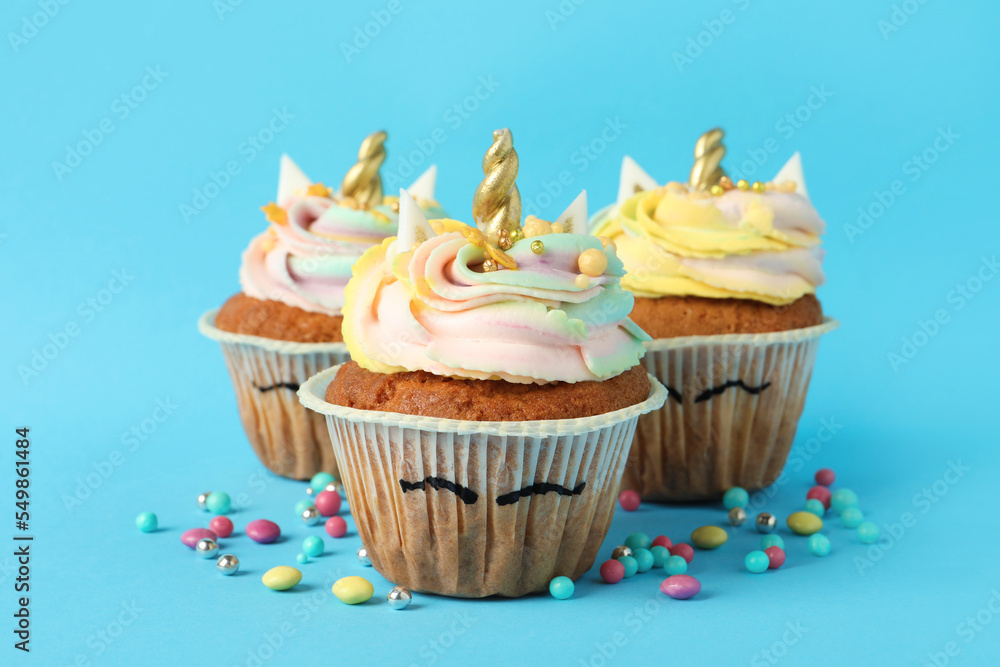 Cute sweet unicorn cupcakes on light blue background Cute sweet unicorn cupcakes on light blue background