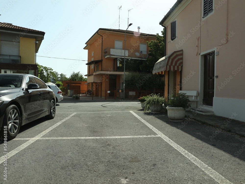 Beautiful street with parking lot and buildings on sunny day Beautiful street with parking lot and buildings on sunny day
