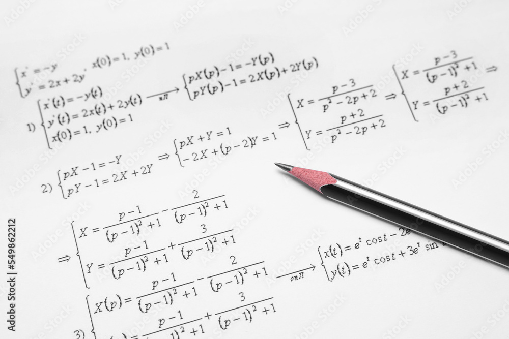 Sheet of paper with mathematical formulas and pencil, closeup Sheet of paper with mathematical formulas and pencil, closeup