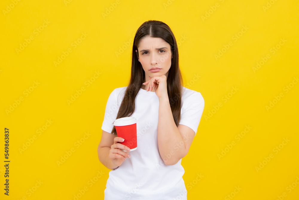 Girl enjoying coffee, isolated on yellow. Young woman hold coffee cup. Girl enjoying coffee, isolated on yellow. Young woman hold coffee cup.