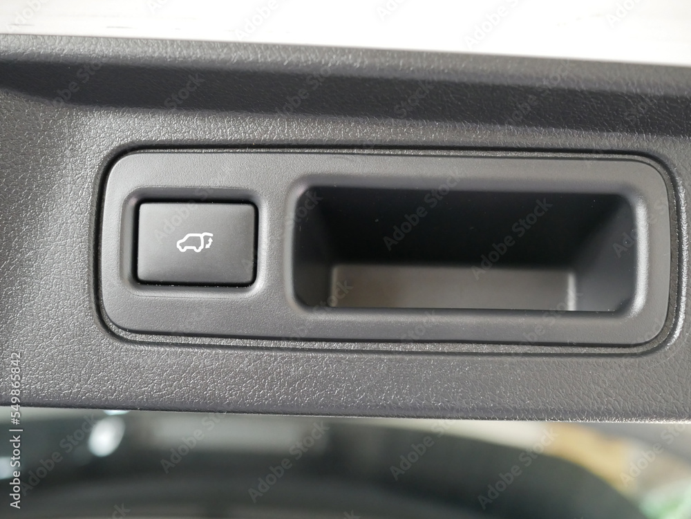 closeup of electric tailgate button in a modern car. closeup of electric tailgate button in a modern car.