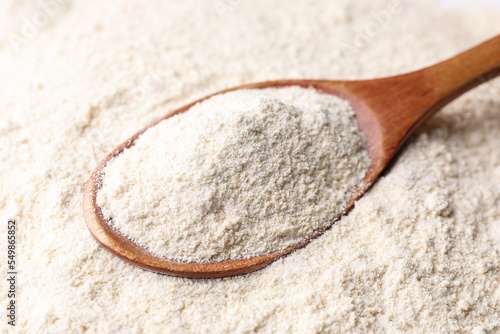 Quinoa flour and wooden spoon, closeup view
