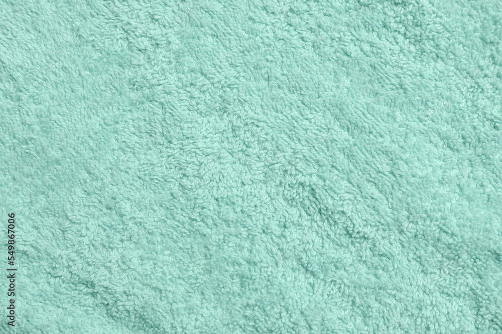 Obraz premium Soft light turquoise towel as background, top view