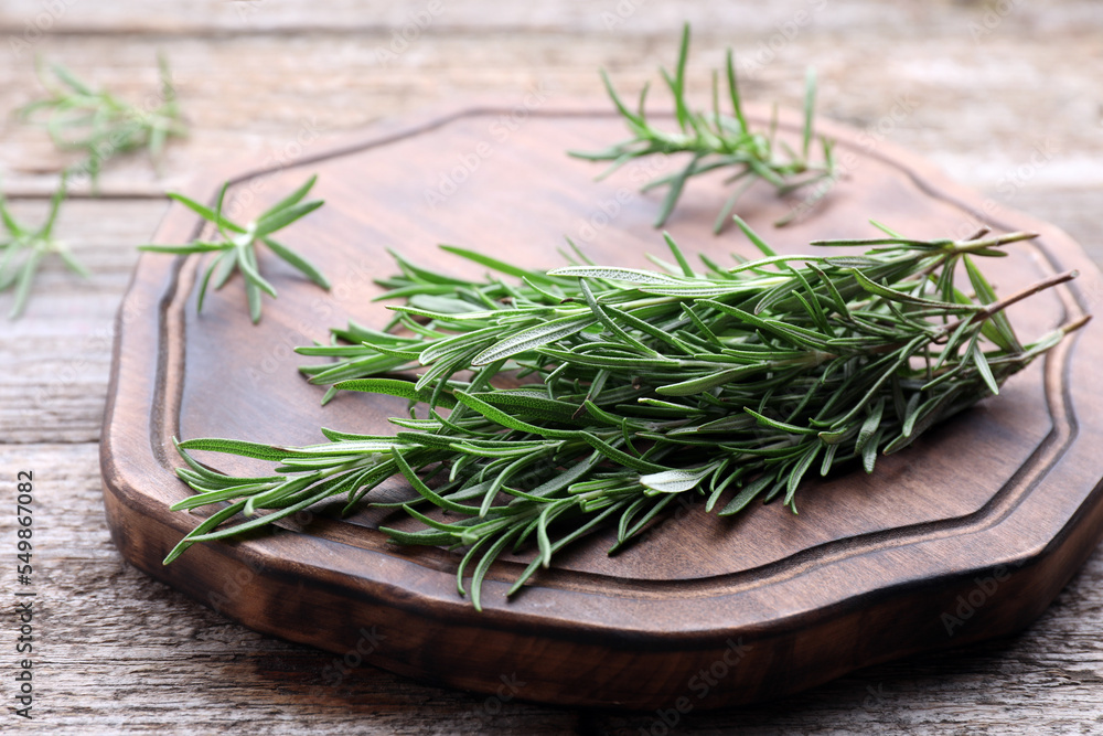 Sprigs of fresh rosemary on wooden table, closeup Sprigs of fresh rosemary on wooden table, closeup