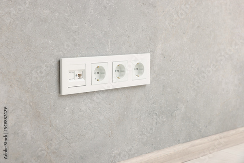 Wall with power outlet sockets in room. Interior design