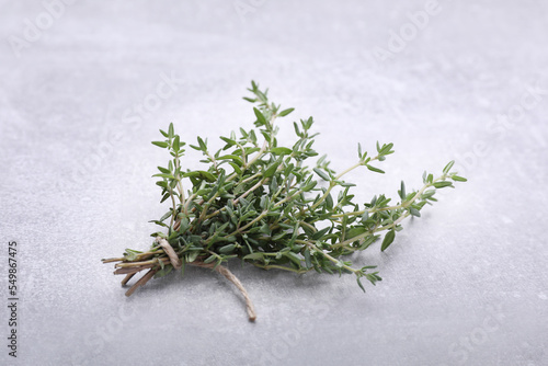 Bunch of fresh thyme on light grey table