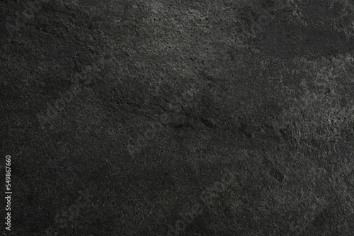 Texture of dark grey stone surface as background, closeup