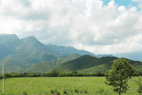 Picturesque view of mountains and green meadow