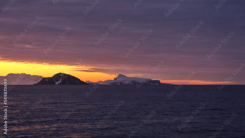 Sunset over the silhouette of mountains at Cierva Cove, Antarctica