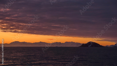 Sunset over the silhouette of mountains at Cierva Cove  Antarctica