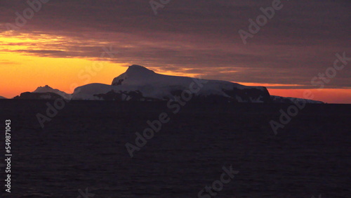 Sunset over the silhouette of mountains at Cierva Cove  Antarctica