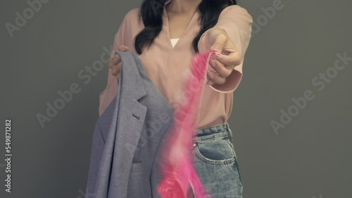 Woman takes out panties from her husband's or boyfriend's jacket pocket. Adultery and divorce concept. Evidence found.
