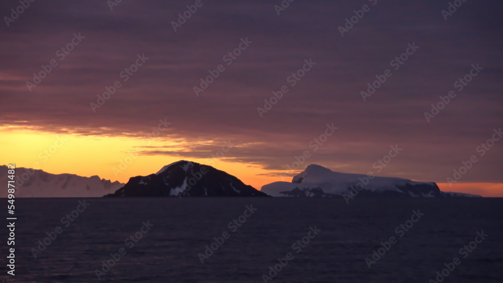 Sunset over the silhouette of mountains at Cierva Cove, Antarctica