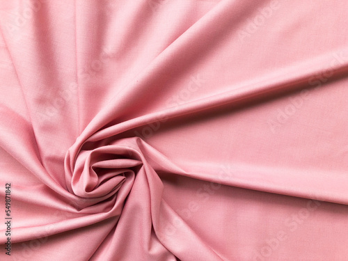 Soft silk textile texture for background. Abstract pink fabric for poster, banner, wallpaper and creative project.