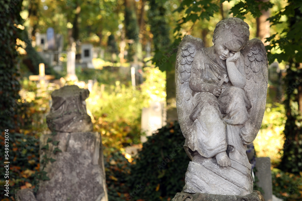 Beautiful statue of angel at cemetery, space for text. Funeral ceremony