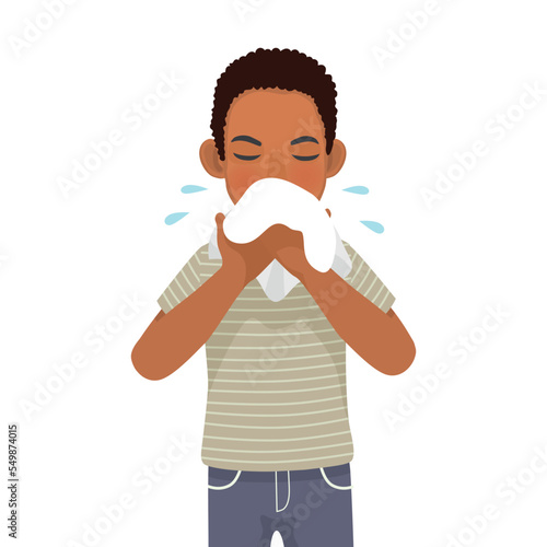 Young African man with runny nose holding a handkerchief or tissue sneezing and blowing because of fever, cold, flu, allergy, virus infection
