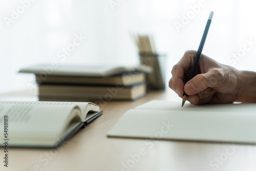 Photography University student studying, writing and reading book or textbook