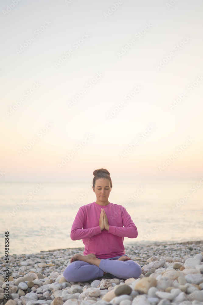 Smiling woman yoga meditation siddhasana lotus namaste hands sea sunset beach sky horizon landscape