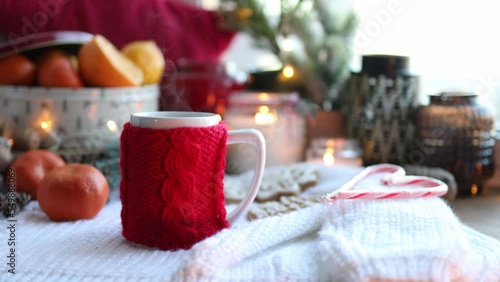 Wallpaper Mural A cup of tea with a knitted red decoration, tangerines, candles, a garland. Christmas atmosphere in the house. Torontodigital.ca