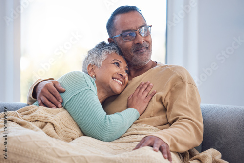 Senior couple, love and home sofa to relax, hug and care while thinking about future, life insurance and retirement together. Senior man and woman in lounge while in happy marriage with support