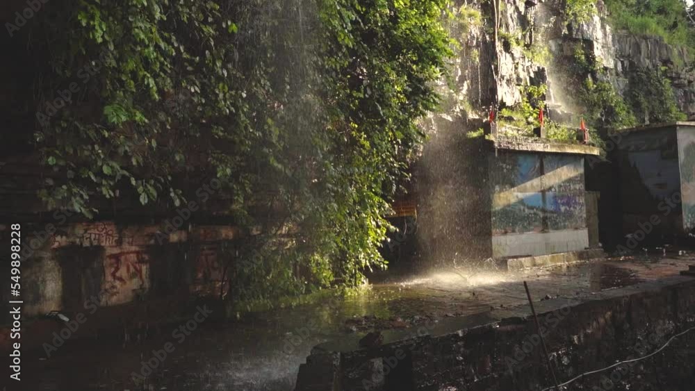 Slowmotion shot of a Waterfall flowing at a temple of Shivpuri Madhya Pradesh , India Slowmotion shot of a Waterfall flowing at a temple of Shivpuri Madhya Pradesh , India