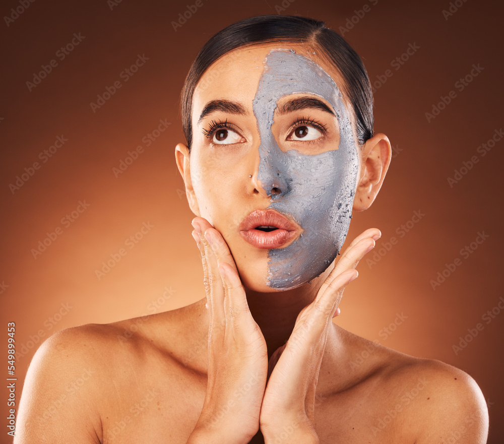 Woman, clay face mask and beauty, facial and expression, dermatology and studio background. Thinking model, charcoal cosmetics and glowing skincare, shine and aesthetic transformation for acne Woman, clay face mask and beauty, facial and expression, dermatology and studio background. Thinking model, charcoal cosmetics and glowing skincare, shine and aesthetic transformation for acne