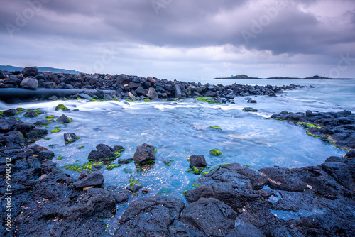 Woljeongri beach in Jeju Island, Korea. Woljeong beach is famous for white sand and beautiful scenery. And there are many beautiful cafes along the Woljeongri coast road. photo