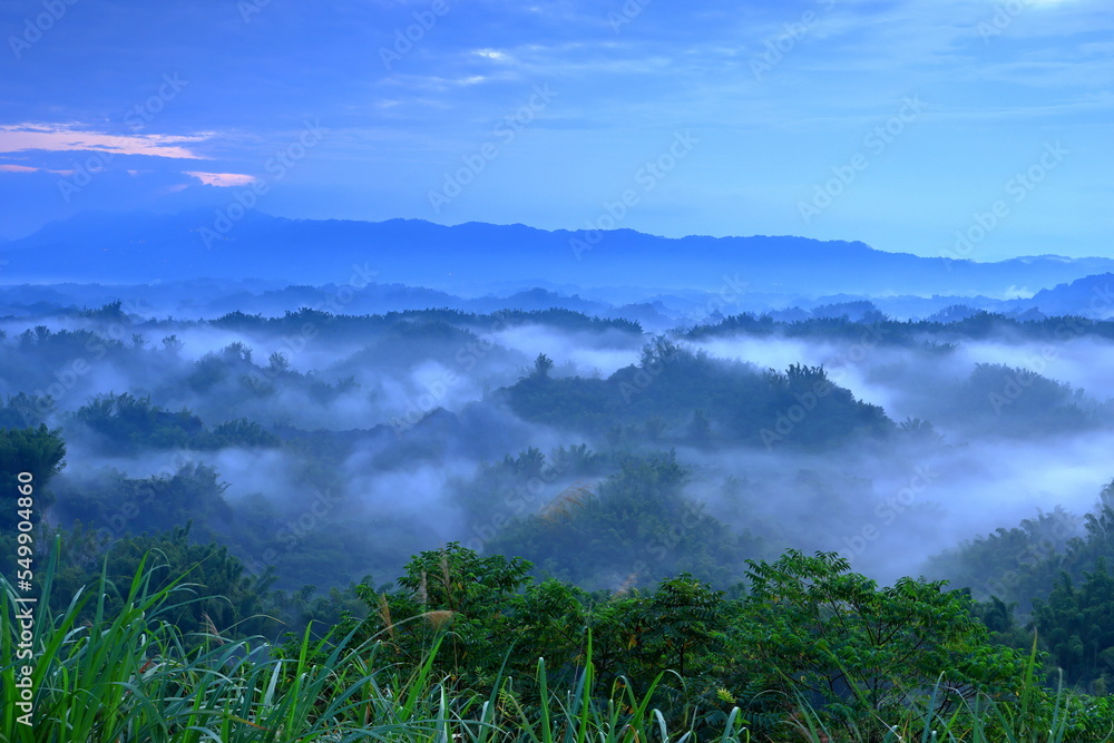 Fototapeta premium Beautiful sunrise mist with mountains and trees in Erliao, Zuozhen District, Tainan Taiwan
