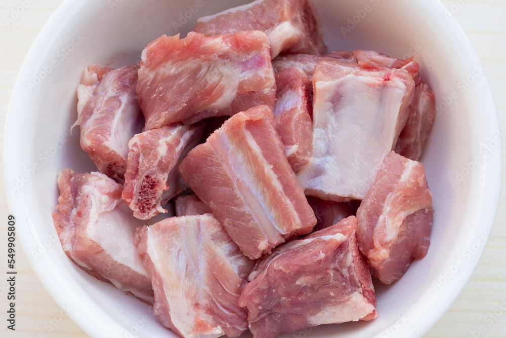 Raw pork ribs in white bowl