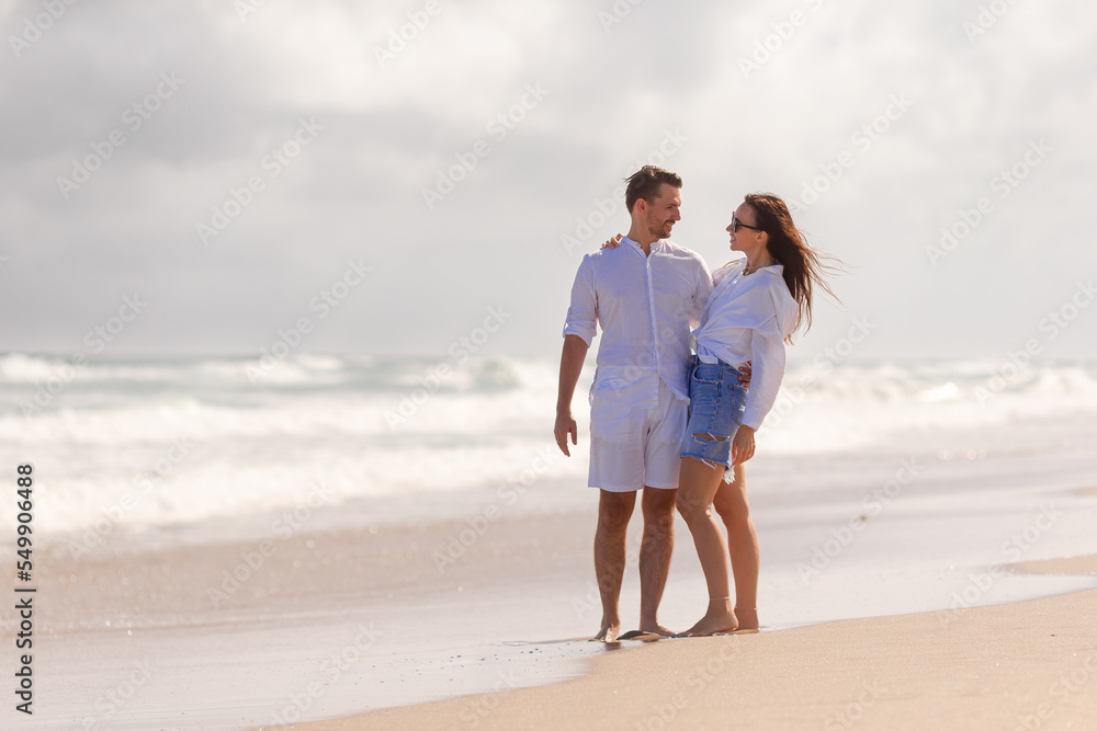 Young couple on white beach during summer vacation Young couple on white beach during summer vacation