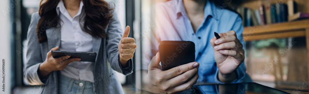 Fototapeta premium Businessman and team analyzing financial statement Finance task. with smart phone and laptop and tablet. Wealth management concept