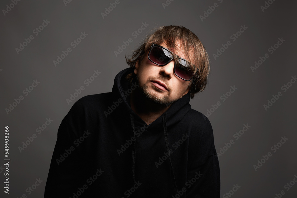 Young Man in unglasses. Funny Boy in a hoodie Young Man in unglasses. Funny Boy in a hoodie