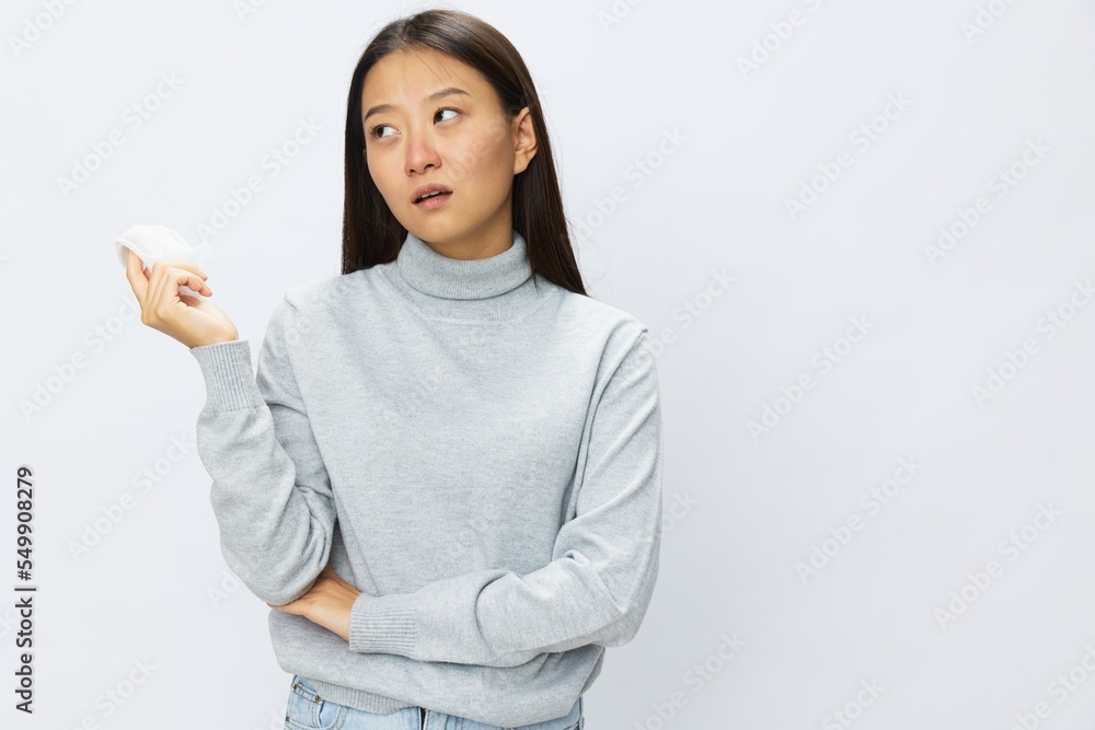 Sad Asian woman holding hand with handkerchief and coughing up flu and cold, stuffy nose viral disease asthma and allergies covid, white background Sad Asian woman holding hand with handkerchief and coughing up flu and cold, stuffy nose viral disease asthma and allergies covid, white background
