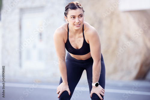 Runner stop, fitness with woman after run and listen to music with earphones, break and exercise outdoor. Running in city street, workout for cardio and health, active with podcast for motivation.